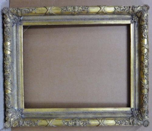 A 19th century and later gilt plaster frame, with foliate and ribbon decoration, the aperture 73cm wide x 92cm high.