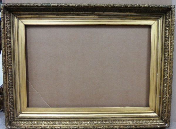 A 19th century gilt plaster frame with foliate decoration, the aperture 92cm wide x 61.5cm high.