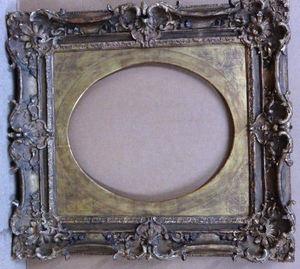 A 19th century and later gilt plaster swept frame, with oval slip, aperture 64cm x 54cm.