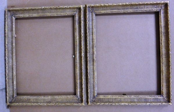 A pair of 20th century gilt plaster frames with reeded and foliate decoration, each aperture 63cm wide x 49.5cm high. (2)