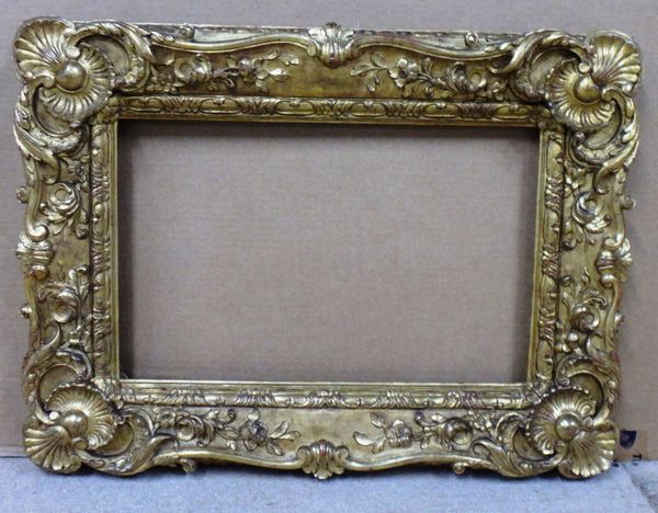 An 18th/19th century carved giltwood swept frame, the aperture 49cm wide x 32cm high. Illustrated