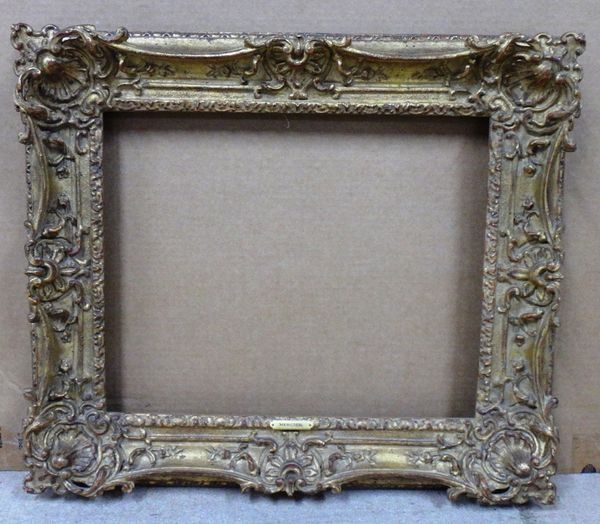 A 20th century Continental gilt plaster swept frame, the aperture 46.5cm wide x 38cm high.