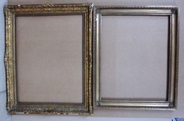 Two 20th century gilt plaster moulded frames, the larger aperture measuring 72cm wide x 92cm high, together with two wooden stretcher frames. (4)