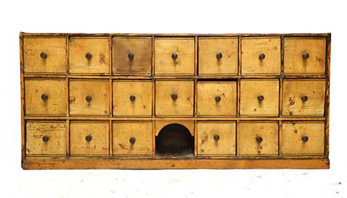 A bank of twenty 19th century and later pine drawers, 120cm wide. Illustrated