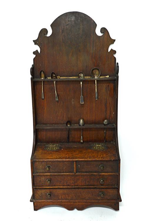 A 19th century oak spoon rack formed as a miniature dresser, with fret cut back over slope front box and two long drawers, 38cm wide x 82cm high. Illu