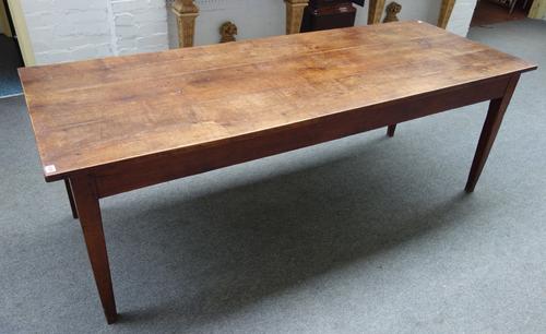 A 19th century French fruitwood kitchen table, the triple plank top on tapering square supports, 78cm wide x 210cm long.