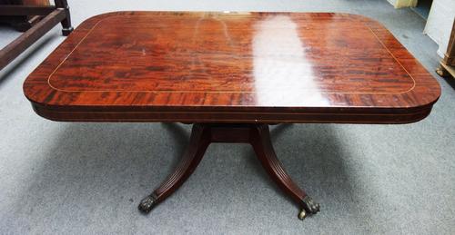 A Regency inlaid mahogany snap-top breakfast table, the rounded rectangular top on turned column and four downswept supports, 107 x 170cm.