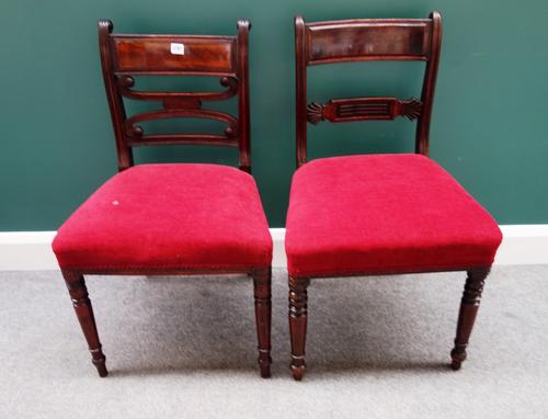 A set of four Regency mahogany framed dining chairs with tablet waist rails and straight front seats, on turned supports, together with a similar set