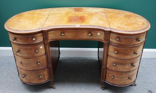 A 19th century mahogany kidney shaped desk, the gilt tooled leather top over nine frieze drawers on tapering square supports, 137cm wide.