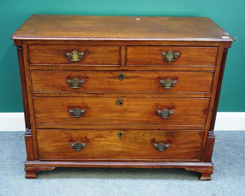 A mid-18th century mahogany chest of two short and three long graduated drawers, flanked by fluted corners, on ogee bracket feet, 110cm wide.