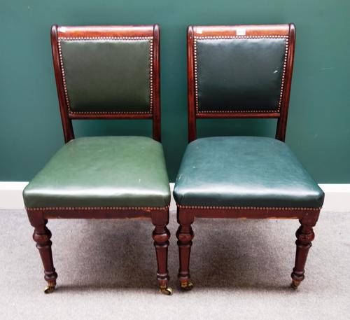 A set of six 19th century mahogany framed square back dining chairs, with studded green leather upholstery, on turned supports.