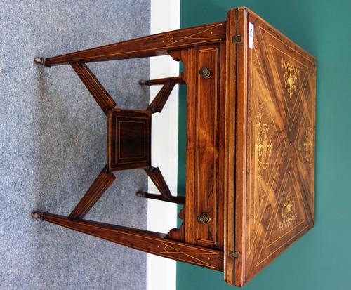 A late Victorian marquetry inlaid rosewood envelope card table, with single frieze drawer, on tapering square supports united by platform undertier, 5