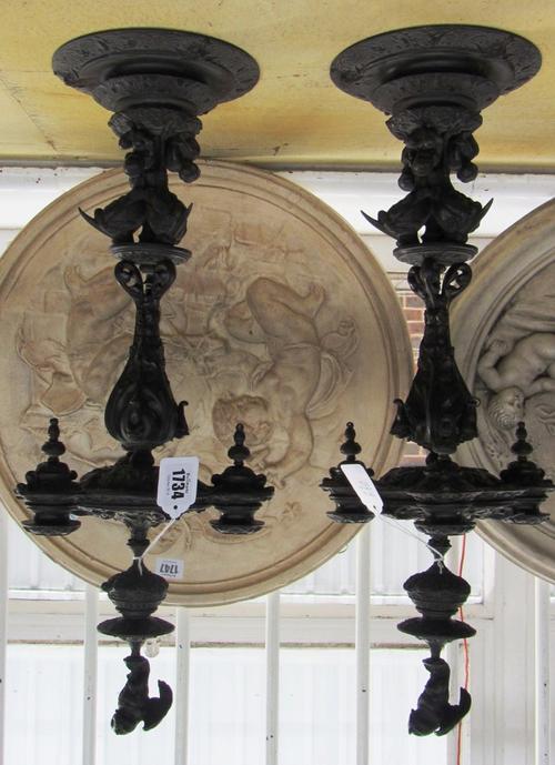 A pair of Victorian oak Arts and Crafts Gothic Revival hall chairs, with solid seats and pierced slab sides (2).