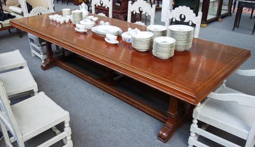 A large late 19th century Italian walnut refectory table on five tapering square supports united by double stretcher on scroll feet, 122cm wide x 307c