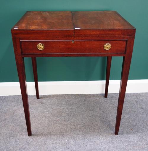 A George III mahogany dressing table, the double fold out top revealing a fitted interior, over dummy frieze drawer, on tapering square supports, 71cm