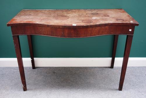 A George III and later mahogany serving table, the serpentine top on four tapering square supports, 124cm wide.