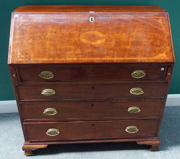 A George III inlaid mahogany bureau, the fall enclosing a fitted interior over four long graduated drawers, on ogee bracket feet, 108cm wide.