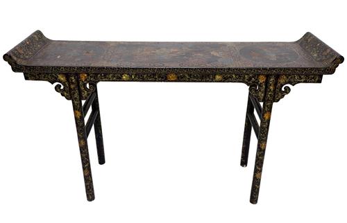 A late 19th century Chinese black lacquer chinoiserie decorated altar table, the rectangular top with up turned ends, on turned supports, 155cm wide.
