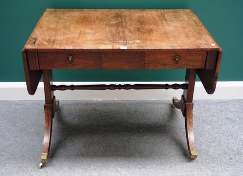 An early 19th century rosewood sofa table, with pair of frieze drawers on slab trestle end standards and four downswept supports, 95cm wide.