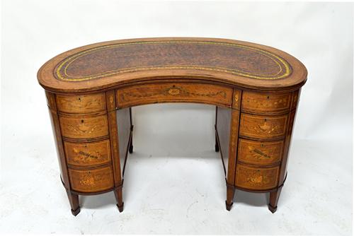 A late Victorian inlaid mahogany and rosewood kidney shape writing desk with nine drawers about the knee on tapering square supports, 120cm wide.  Ill