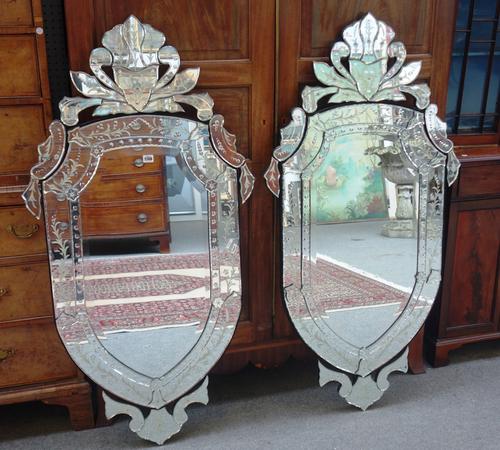 A pair of 20th century cut and etched Venetian glass wall mirrors, each of shield shape outline, 71cm wide x 140cm high, (2).