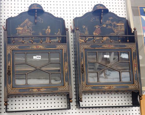 A pair of early 20th century black lacquer chinoiserie decorated hanging wall cabinets, each with single astragal glazed doors, 44cm wide, (2).