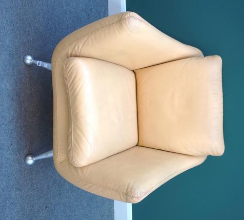 J H Hicolity; a 20th century yellow leather upholstered easy armchair, on four chrome supports.