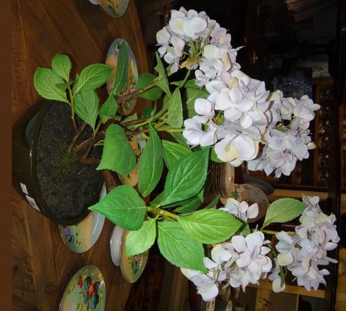 A pair of mahogany framed rectangular footstools, on early 19th century carved mahogany baluster supports, each 128cm wide.