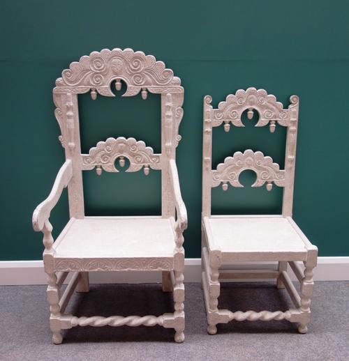 A set of eight white painted Charles II style dining chairs, with carved crest and waist rail, acorn finial mounts, on block, turned and barley twist
