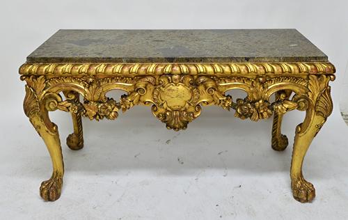 A George III style console table, the rectangular marble top over a carved and pierced giltwood base, centred by a cartouche, amongst floral sprays ra