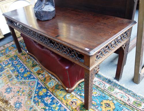 A George III and later mahogany serving table, the rectangular top over pierced fret cut frieze, on blind fret cut block supports, 183cm wide.