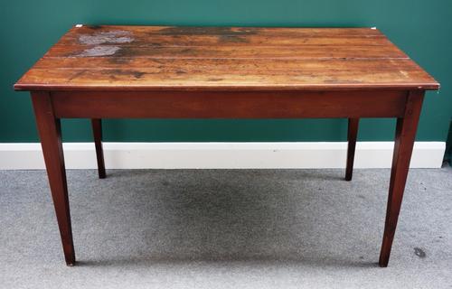 A 19th century French plank top kitchen table, on tapering square supports, 71cm wide x 132cm long.