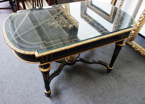 A 19th century gilt metal mounted ebonised centre table, the rounded rectangular top with inlaid brass marquetry detail, over single frieze drawer, on
