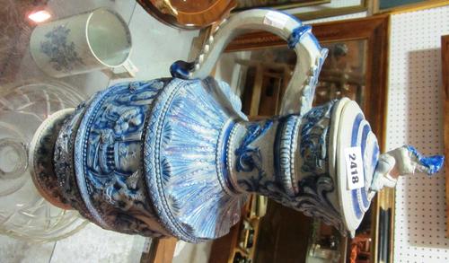 A Regency mahogany and ebonised floor standing two tier open bookcase, with outstepped turned supports, on brass caps and castors stamped 'Cope & Coll