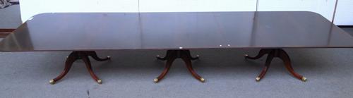 A George III style mahogany triple pillar dining table, each pillar with turned column and four downswept supports, 137cm wide x 488cm long.