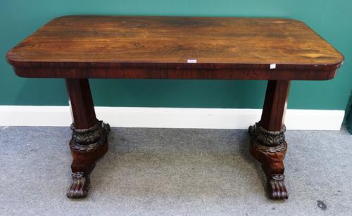 B. Taylor & Sons, London; a William IV rosewood centre table, the rounded rectangular top on a pair of tapering octagonal columns, with carved collars