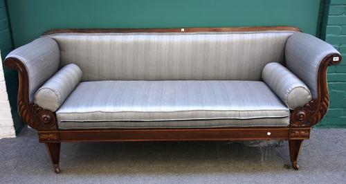 An early 19th century North European rosewood framed sofa, with rollover arms and straight front seat, on tapering octagonal supports, 214cm wide.