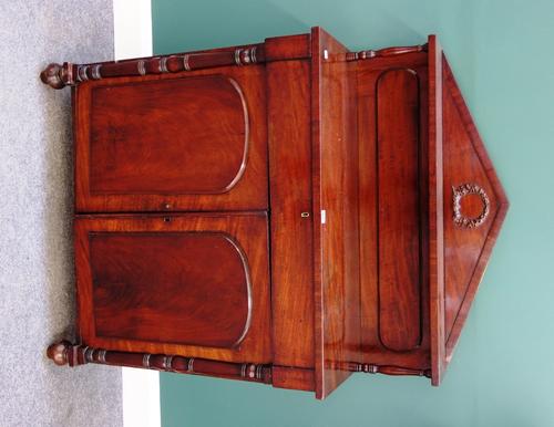 An early Victorian mahogany chiffonier, with architectural ledge back over single drawer and a pair of arch panel cupboards, flanked by split turned c