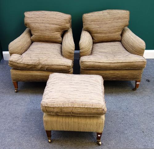 A pair of 20th century easy armchairs on tapering square supports and a matching foot stool.