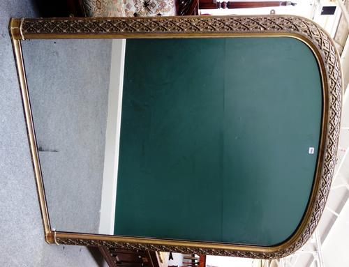 A Victorian gilt framed arch top overmantel mirror, the frame relief carved with oak leaves within a diamond lattice, 145cm wide x 180cm high.