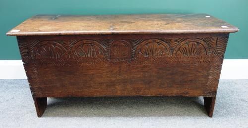 A 17th century oak coffer of plank construction, with chip work and carved decoration, 98cm wide.