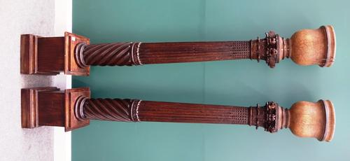 A pair of 19th century and later fluted and spiral fluted Corinthian columns, on stepped square bases, later fitted as uplighters, 199cm high.