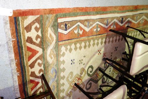 A machine made carpet with geometric designs, ivory and peach ground.  J7