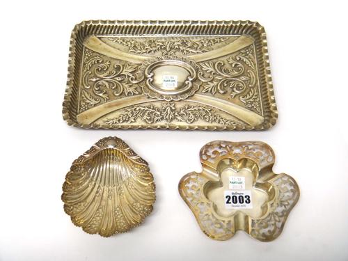 Silver, comprising; a rectangular dressing table tray, with embossed decoration, Birmingham 1900, a Victorian butter shell, raised on three feet, Shef
