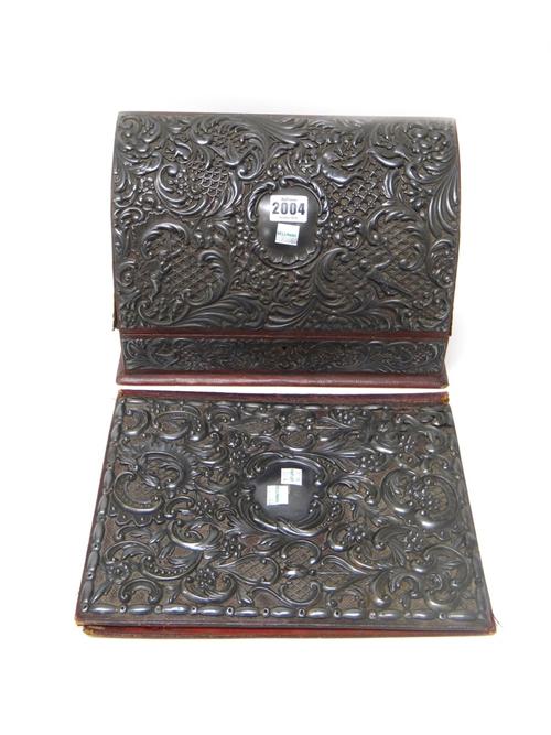A Victorian silver mounted leather stationery box, the interior with compartments, the front with an applied silver panel, decorated with cherubs and