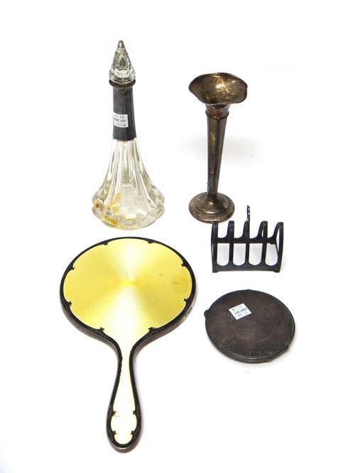 Silver and silver mounted wares, comprising; a lady's hand mirror, with yellow and black enamelled decoration, London 1928, a circular powder compact,
