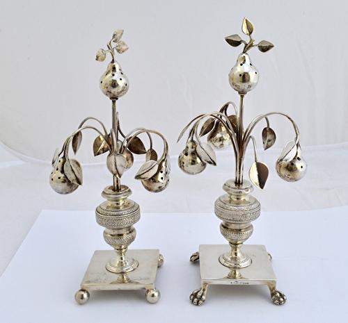 Two similar European pomanders, each formed as four pears with foliate sprays at intervals, raised on a square base, one having paw feet and the other