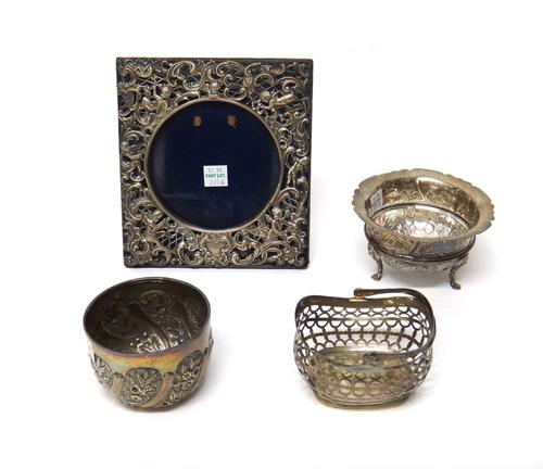 Silver and silver mounted wares, comprising; a Victorian bonbon basket, with pierced decoration and with a swingover handle, London 1894, a square pho