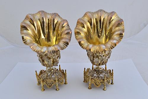 A pair of Turkish parcel gilt vases, each of flared open form, with applied floral, foliate and bird decoration and on a hexagonal cast foot, having s