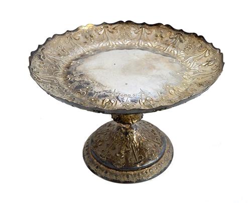 A late Victorian silver table centrepiece cake stand, of shaped circular form, decorated with flowers and fruit, raised on a circular foot, diameter 2